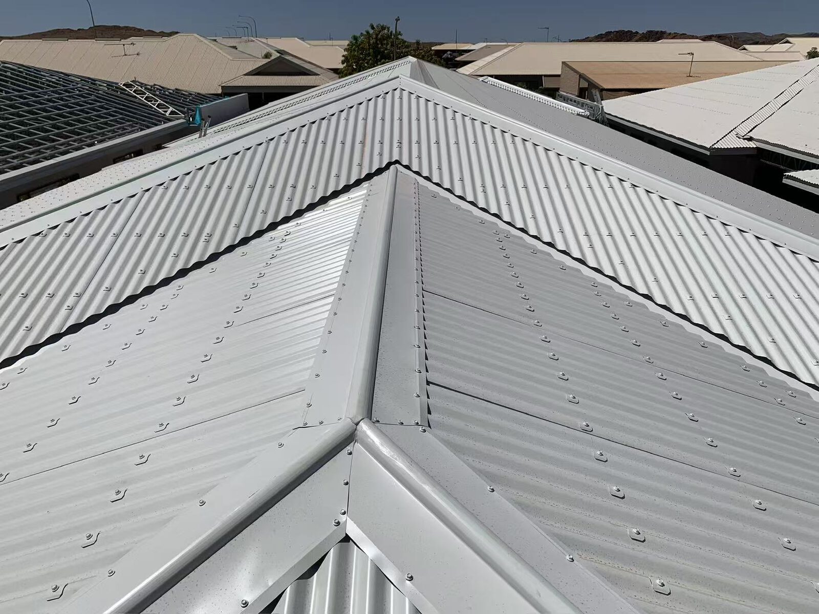 Karratha new Colorbond roof ridge with hills in background