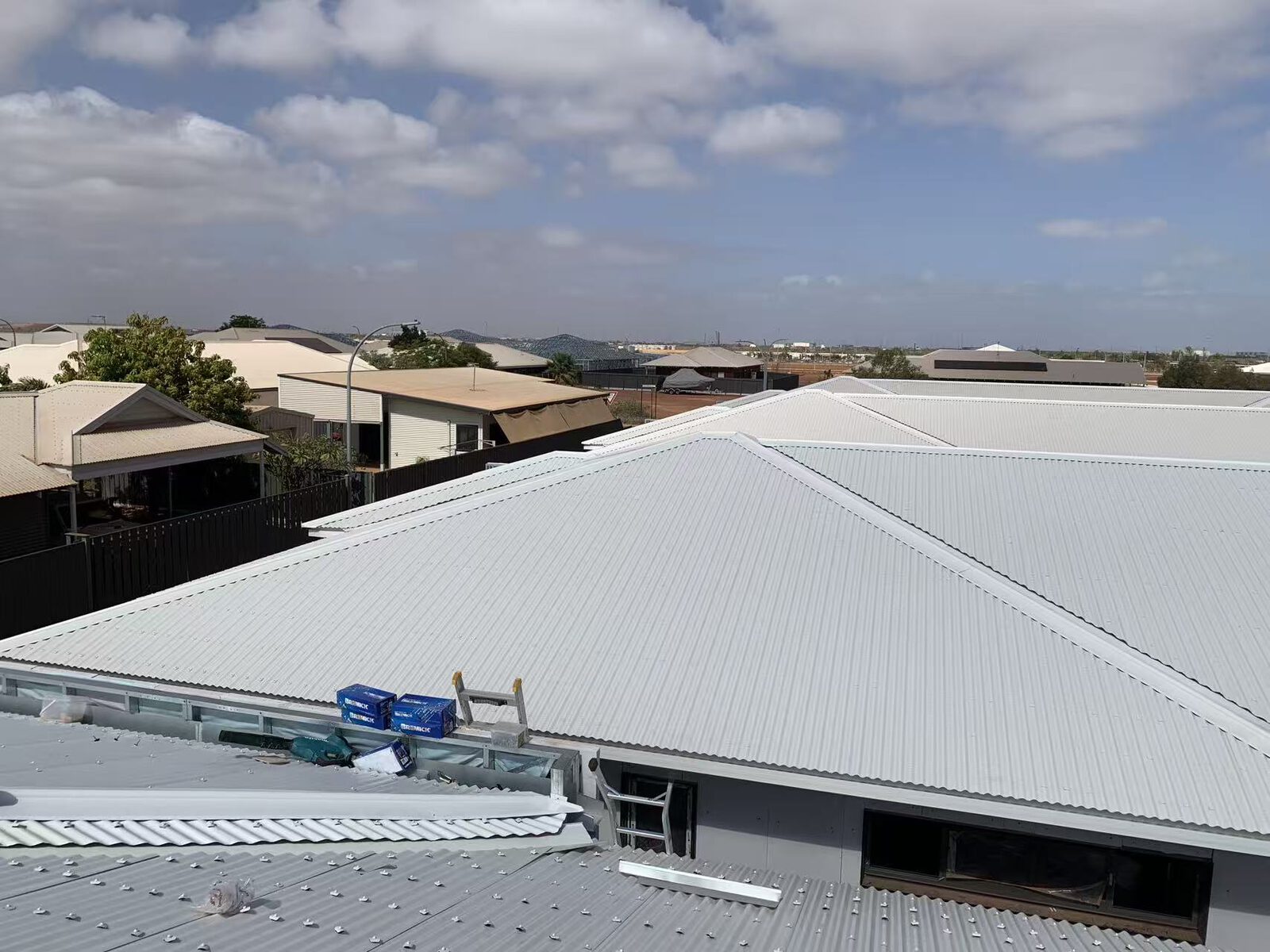 New roof in final stages with materials staged on site